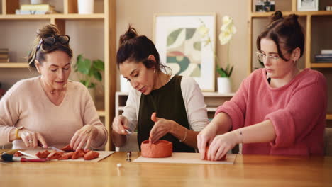 women creating pottery