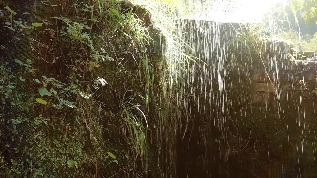 Taking cover from the falling rain in a small cave like stone shelter