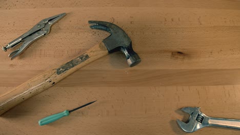 top-down view of tools on tabletop grabbed one by one