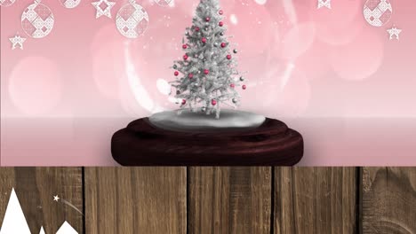 Animation-of-snow-falling-and-glowing-spots-over-snow-globe-with-tree-on-pink-background