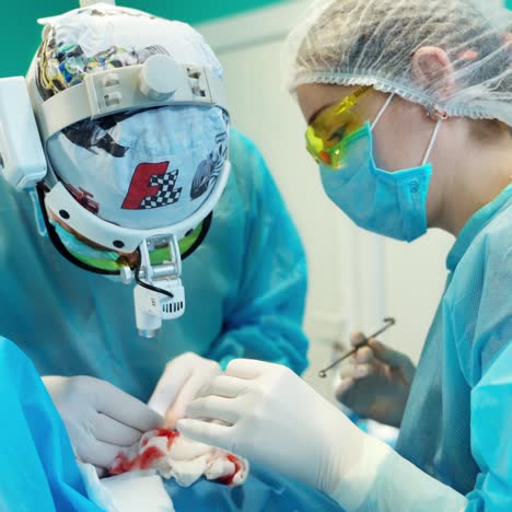 medical team performing cosmetic surgery operation. otoplasty surgery. correction of protruding ears.
