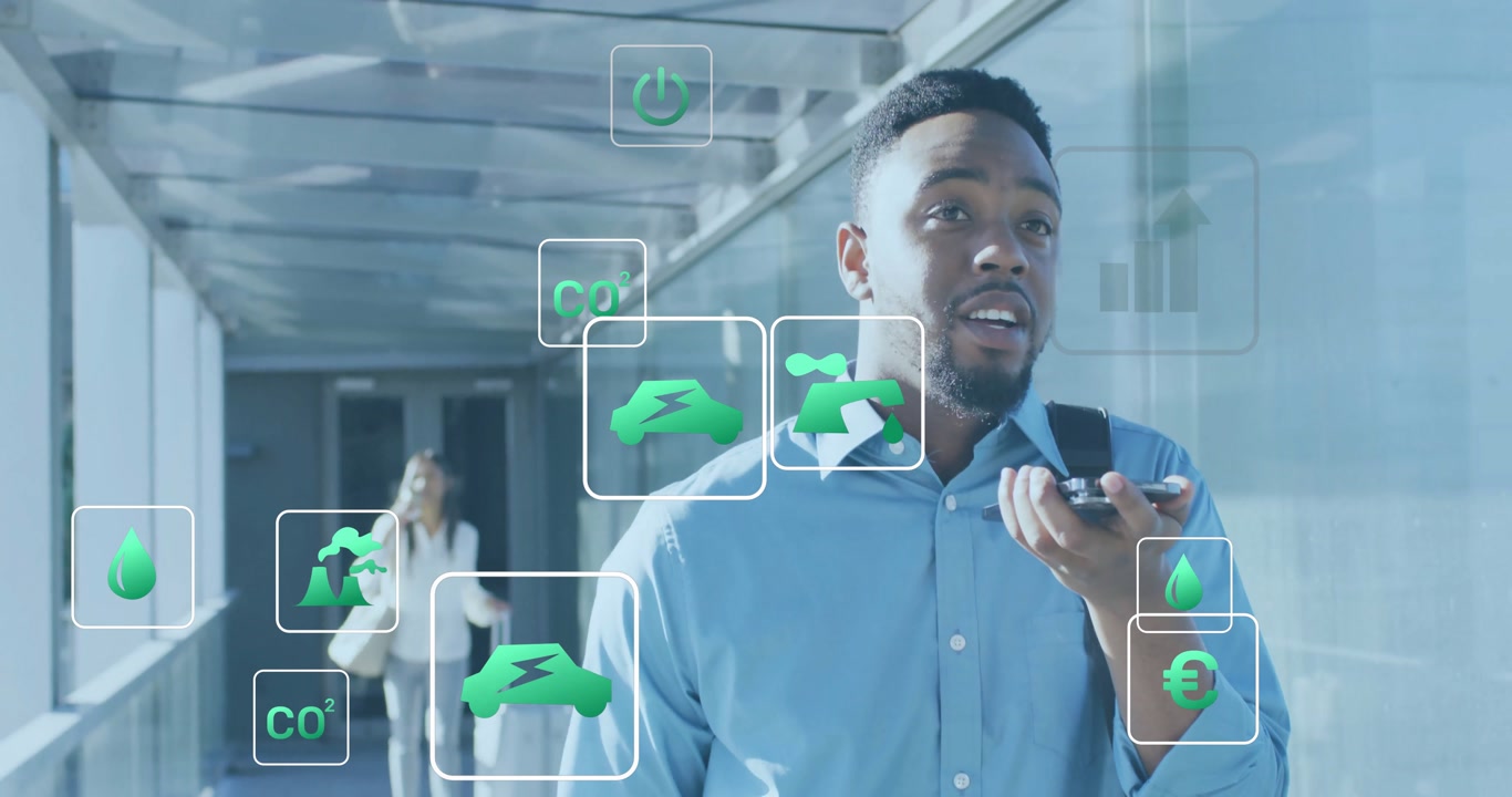 Businessman speaking into phone in airport activating floating eco icons and monitoring metrics