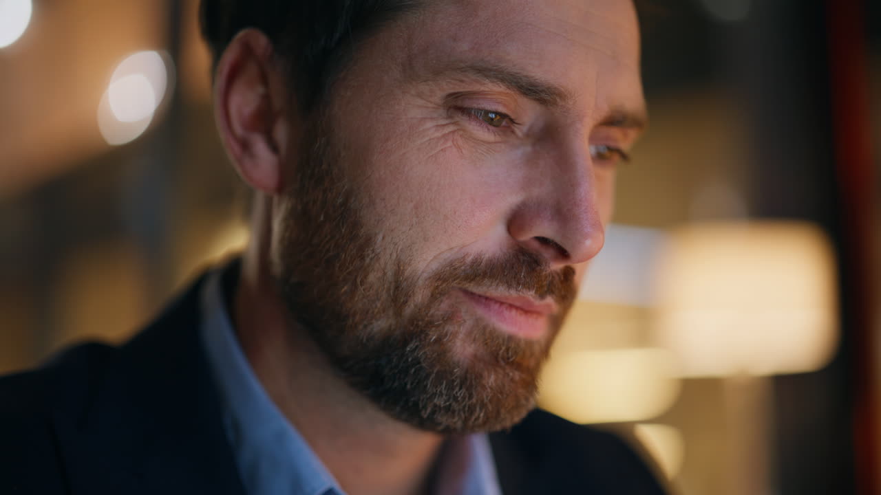 Closeup businessman working night under lamp light. Smiling entrepreneur reading