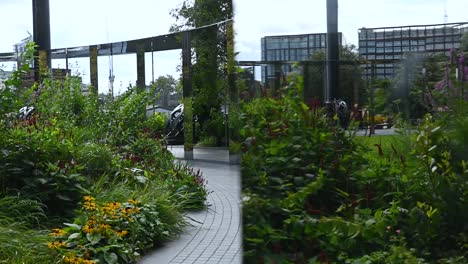 Looking-through-the-glass-within-the-Gasholder-Park,-Regents-Canal-Path,-London,-United-Kingdom