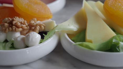 close-up of a cheese plate with dried apricots, walnuts and mozzarella