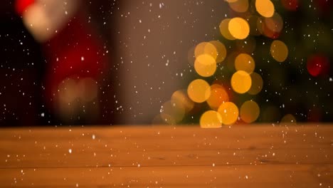 Animation-of-snow-falling-over-blurred-room-and-christmas-decoration