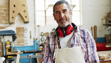 Portrait-of-smiling-carpenter-standing