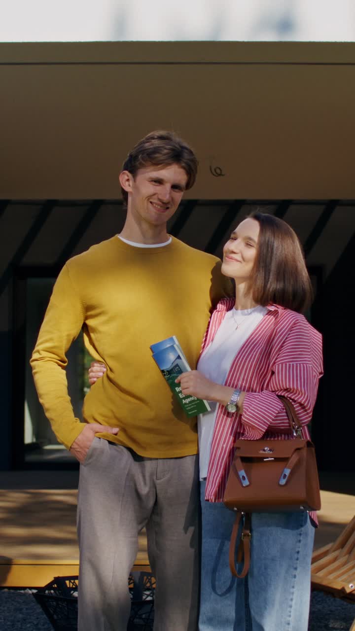 Couple in front of modern house