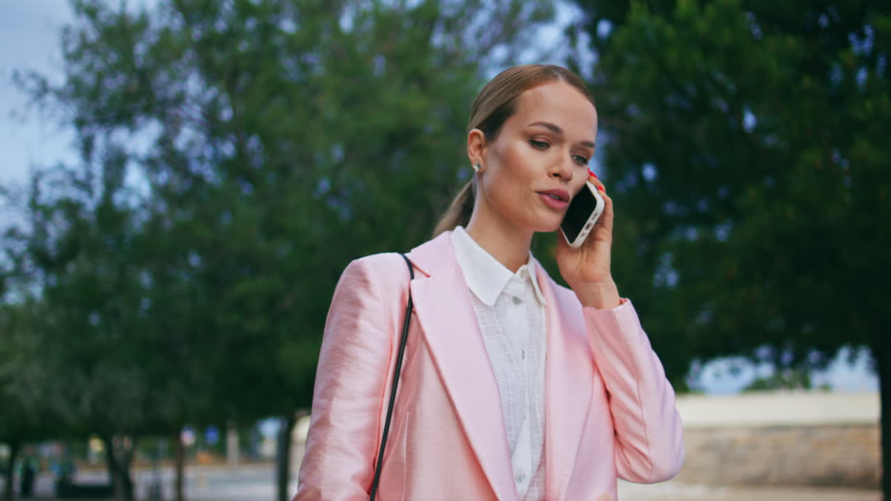 회사 직원이 스마트폰으로 이야기하고 길거리를 가까이 걸어다니며 여자와 이야기하고 있습니다.