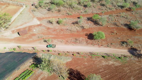 aerial of truck driving past farms in a beautiful african landscape