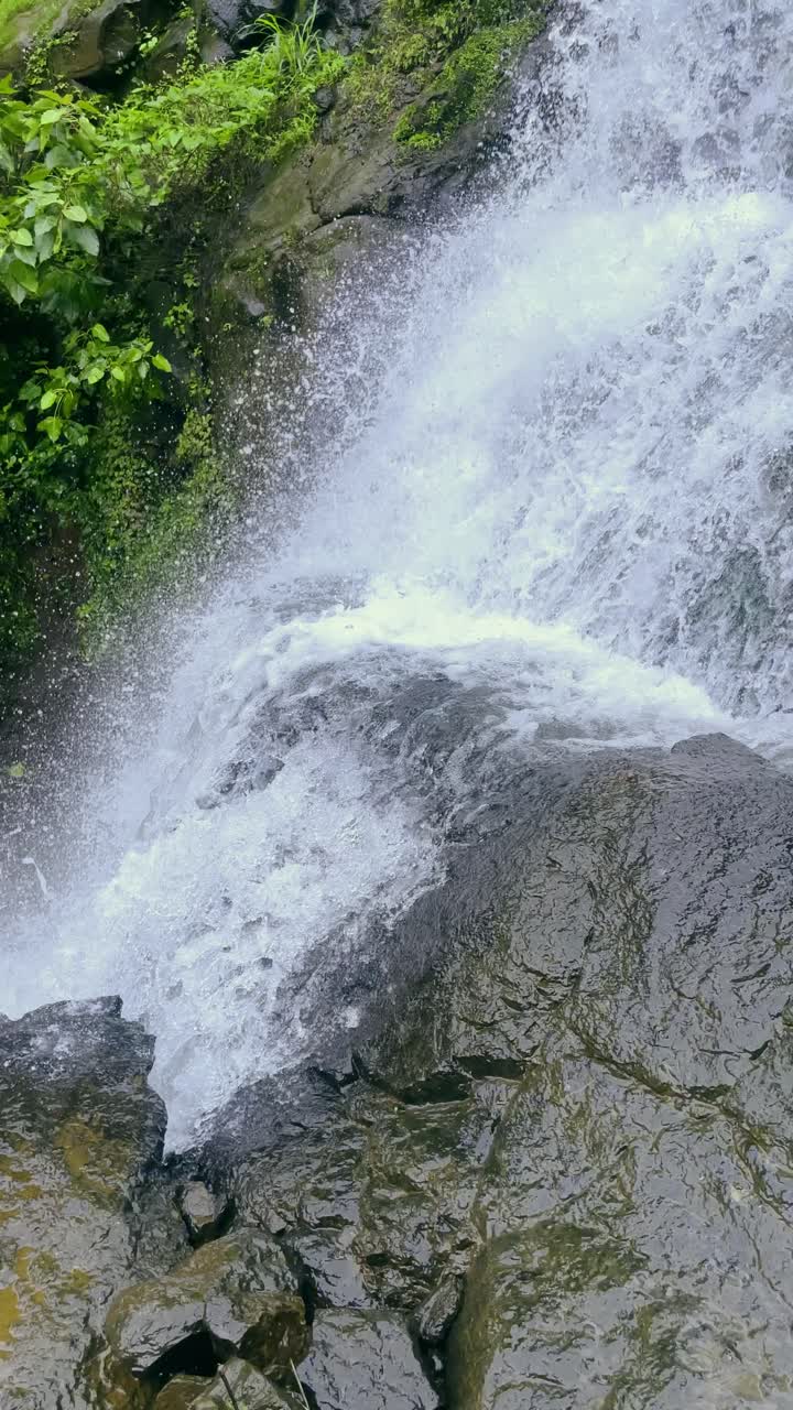 Close up view of a breathtaking waterfall cascades down mountain cliffs. Lush green forests surround the scene, creating a picturesque landscape Bhandardhara Maharashtra India 4K