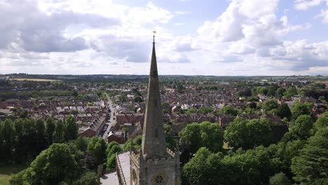 Establishing-descending-aerial-view-down-Holy-Trinity-church-steeple-,-Stratford-Upon-Avon,-Warwickshire-English-town-landmark