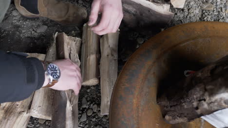 man building campfire in cave