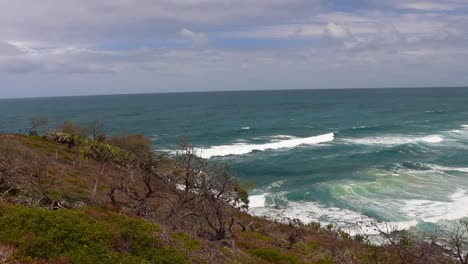 high viewpoint of breathtaking ocean waves coming onto the beach on the noosa national park hike in noosa heads, australia