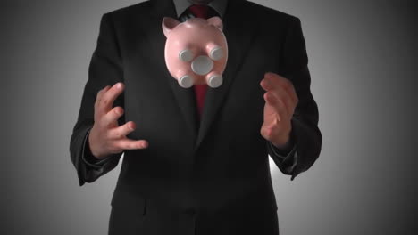 man tossing a piggy bank