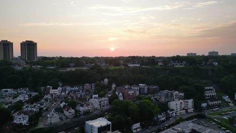 drone sunset aerial over fort lee nj showing the hudson river and new york city skyline in warm evening light with clear skies and scenic city backdrop