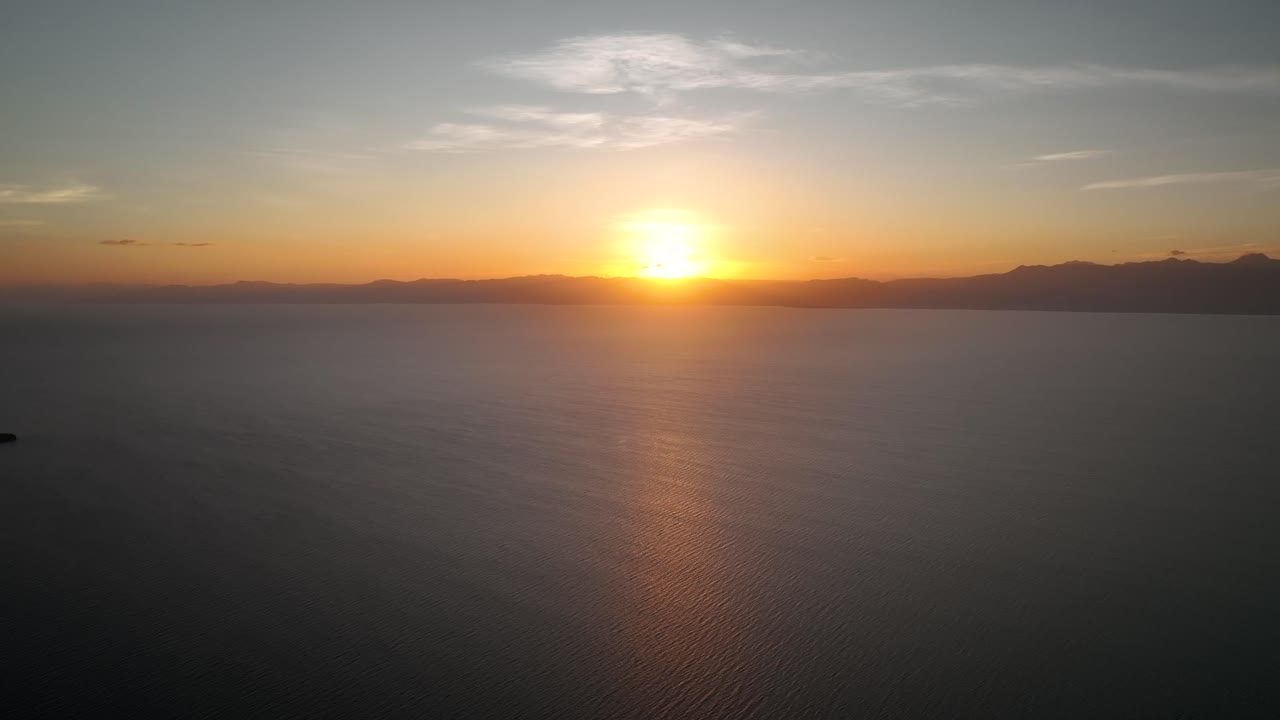 Sunset With Golden Sky Over The Sea In Moalboal Town, Cebu Island, Philippines. Wide Shot