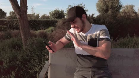 man having a video call in a park