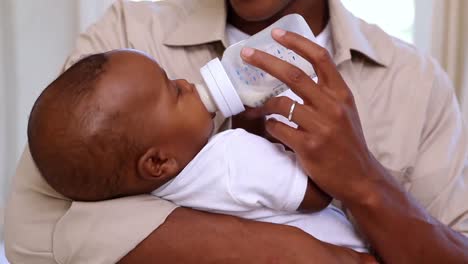 Happy-father-feeding-cute-baby-son