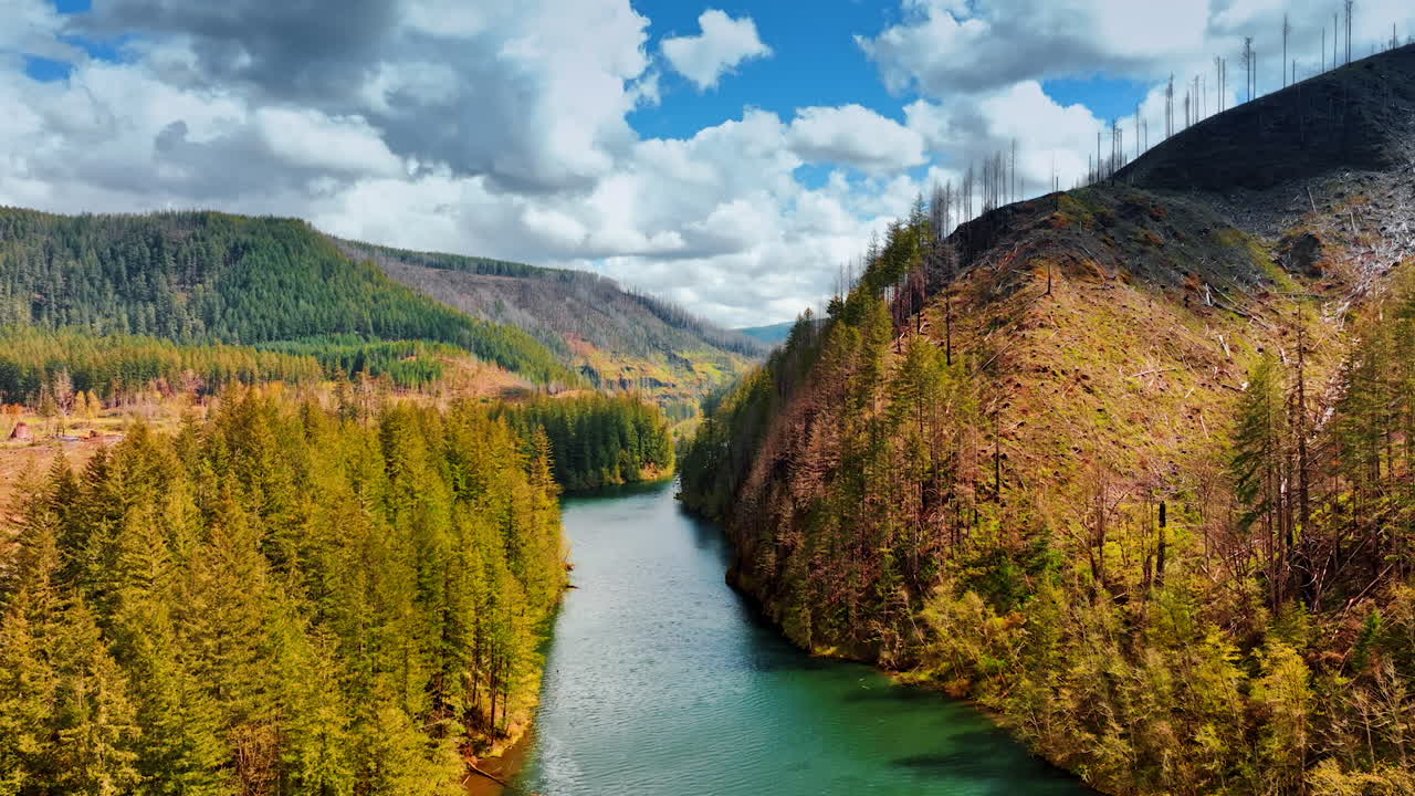 Going up over the river in mountains with sea-blue water. Scenic view on the rocky landscape in Oregon State, the USA on sunny daytime. Mt. Hood National Forest.
