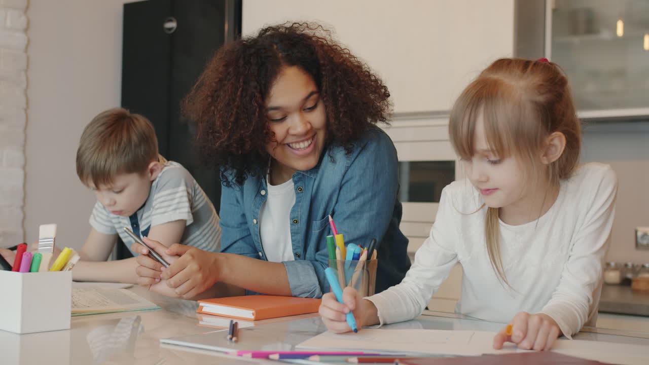 Children learning and drawing together in a kitchen