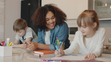children learning and drawing together in a kitchen