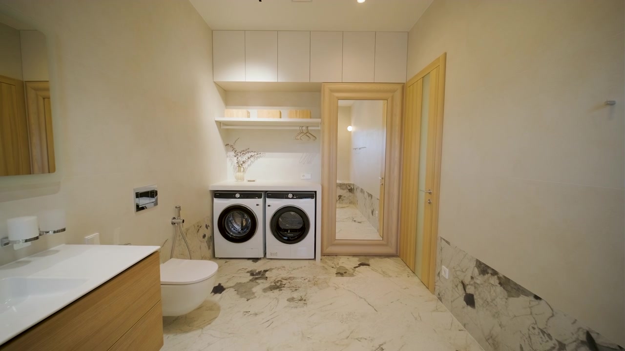 Modern Laundry Room Interior with Marble Flooring and Built-in Appliances