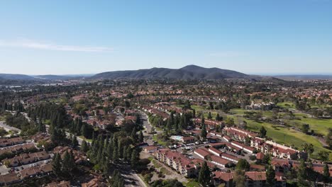 aerial view of north san diego suburb with mountain in the background and blue sky