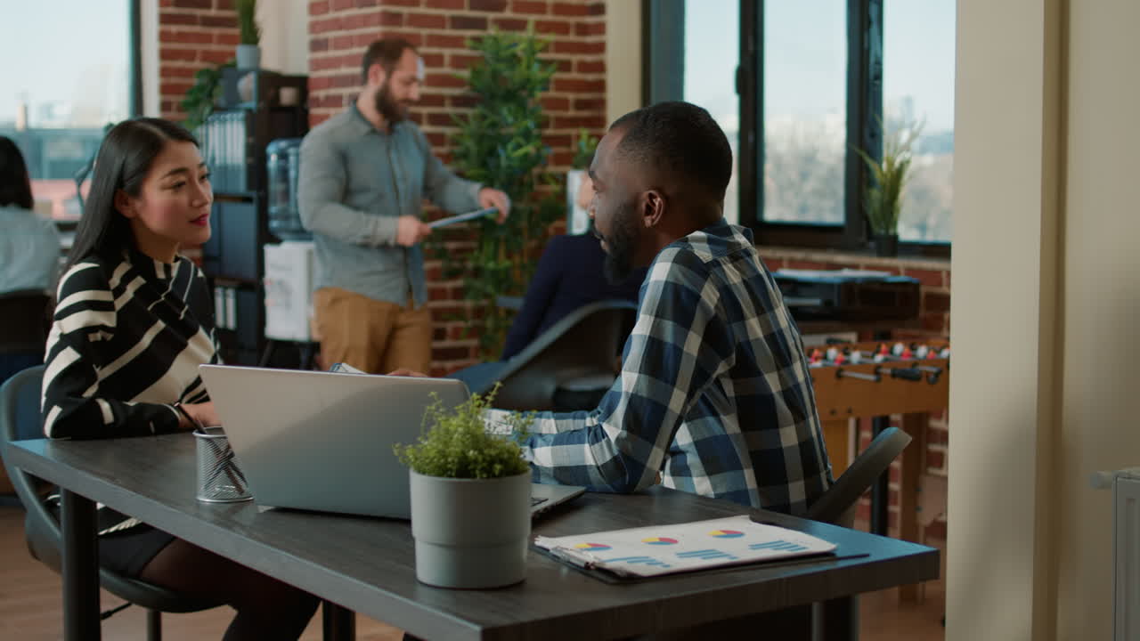 Female worker interviewing male applicant at job application