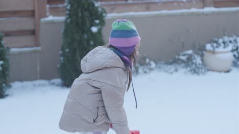 grandfather and granddaughter having fun in the snow