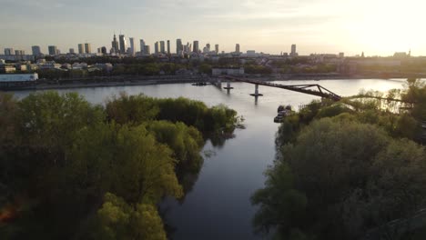 sunset over warsaw skyline and vistula river traffic view