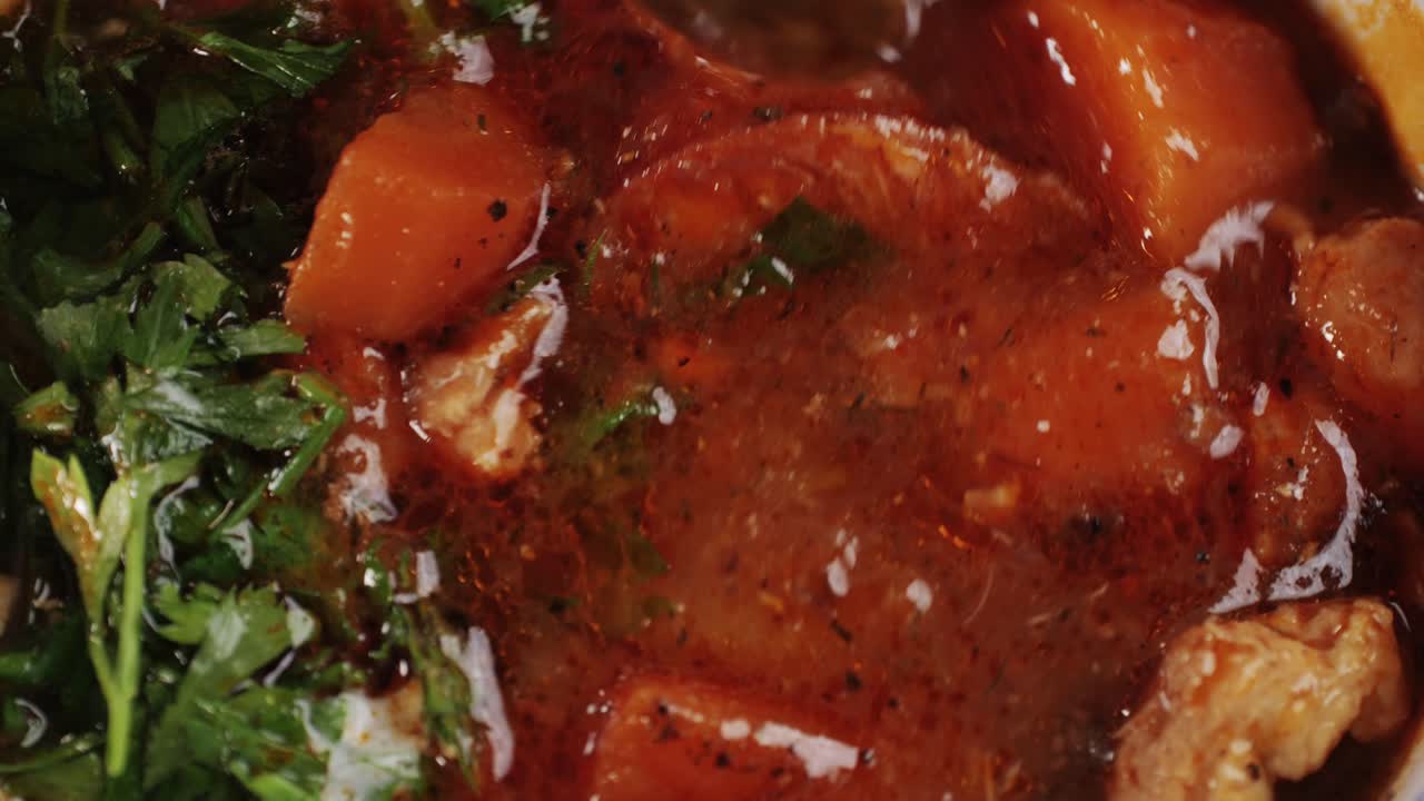 Goulash soup with potato, carrot, meat and bolgarian papper and parsley cilantro in top. Shurpa soup. High quality 4k footage