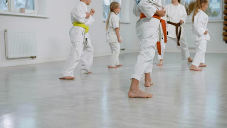 kids in white kimono in martial arts class