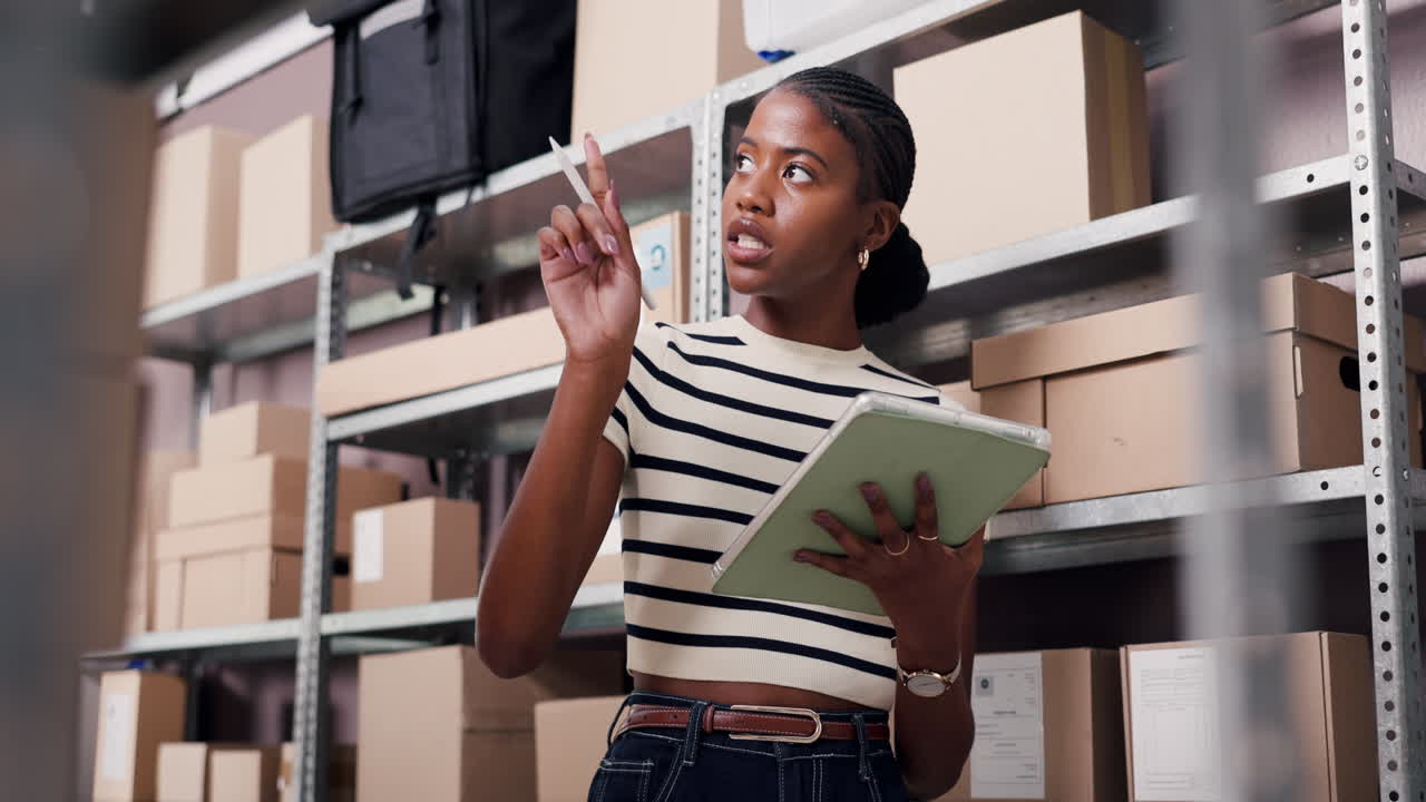 Young Woman Checking Inventory in Warehouse with Digital Tablet