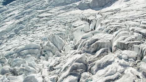 close-areial-fly-over-ice-glacier-with-deep-crevasses-and-cracks,-Aerial-fly-over-of-allalingletscher-switzerland