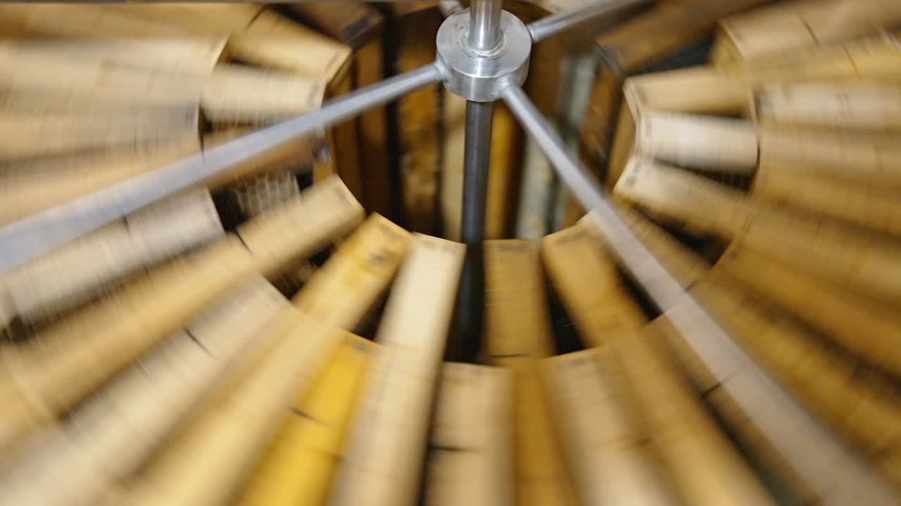 Centrifuge device is spinning to make honey drip away from cells. Special apparatus work for getting fresh honey.
