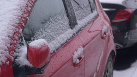 red car covered in snow