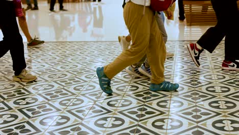 people walking together on patterned tiles