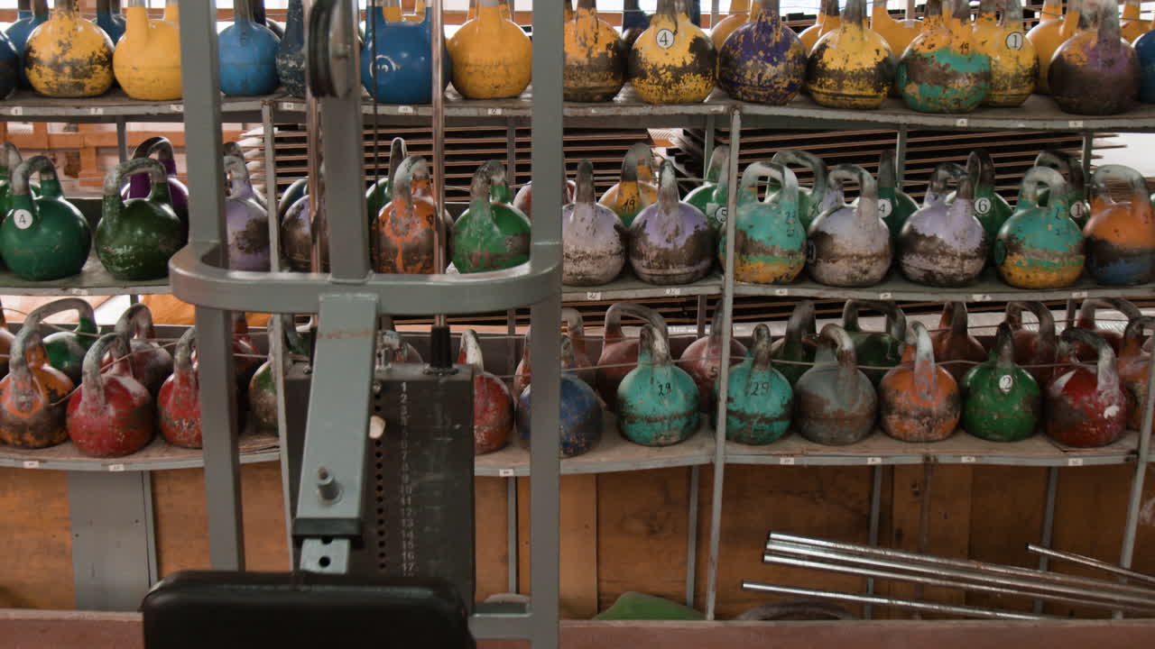 Colorful Kettlebells Lined Up in a Gym