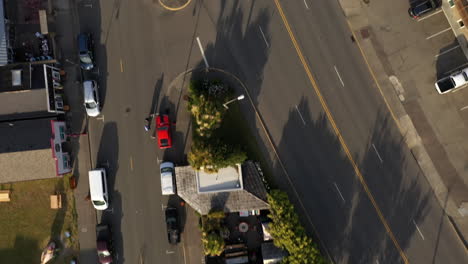 aerial view of cars parked outside business establishments in a small town in bandon, oregon at daytime - top-down drone