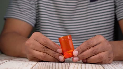 person holding an orange pill bottle