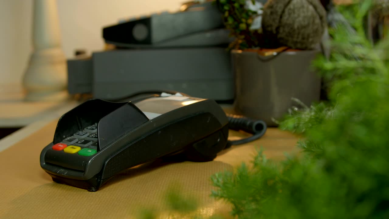 mano ofreciendo tarjeta de crédito para el pago en la caja en la guardería