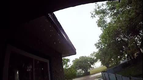 extreme slow motion - rain drop off the roof of a house during a wet rain day