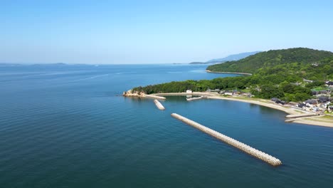 minimalist drone shot over small island with wave breaker in japan