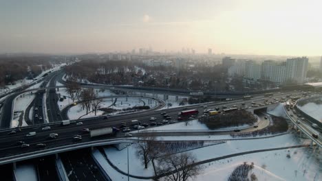 aerial establishment interception with car traffic in warsaw, capital of poland, snowy and icy road, aerial view with drone