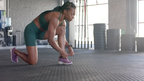 stretching in gym, woman in athletic wear preparing for workout session, copy space