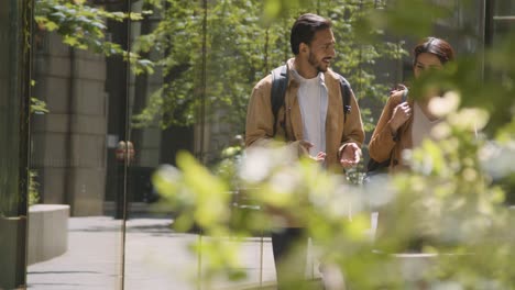 muslim couple on date talking as they walk along city street together 4