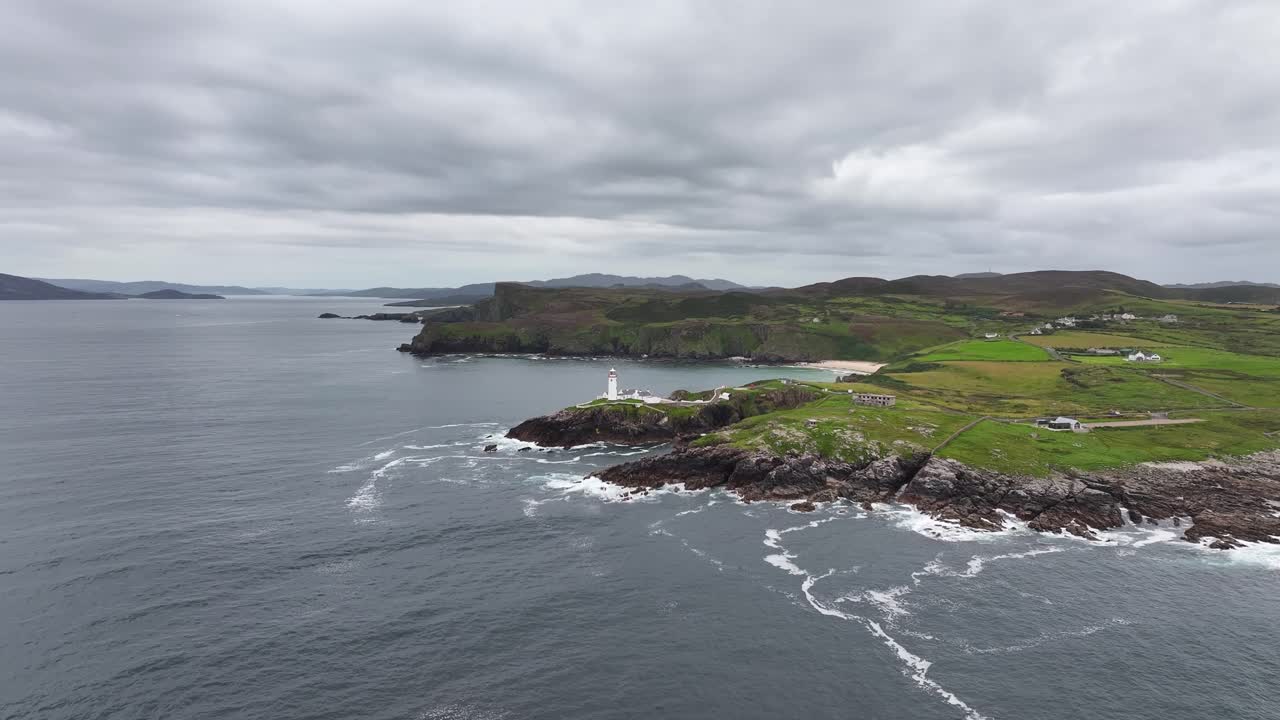 Dramatic coastal view of Fanad Head Lighthouse, serene Atlantic atmosphere