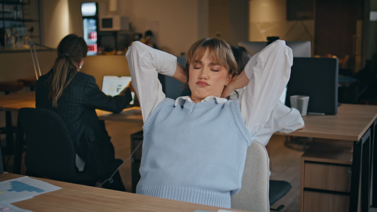 Tired businesswoman stretching body massaging head at laptop workplace closeup