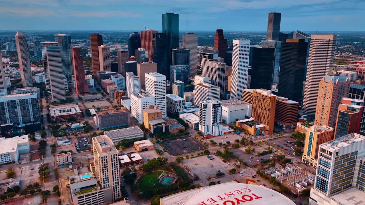 Houston, USA, 24. november 2025: Højvinkel luftfoto af Houstons downtown stadionområde. Hævet perspektiv af en indendørs sportsarena omgivet af byens parkeringspladser og fjerne skyskrabere.